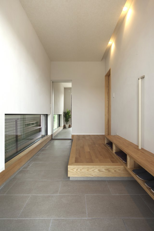 地窓が空間に安定感と、横方向への広がりをもたらします。
また、奥に鏡張りの扉を設けることで、奥行きが生まれ、伸びやかさを感じる玄関となりました。