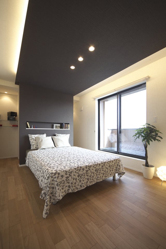 寝室の天井を一部下げて、空間に変化を持たせました。
下がり天井の両側から広がる間接照明が、夜をお洒落に演出します。