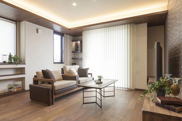 親世帯のLDKには窓の上に下がり天井をあしらい、間接照明を組み込んで表情豊かに演出しています。