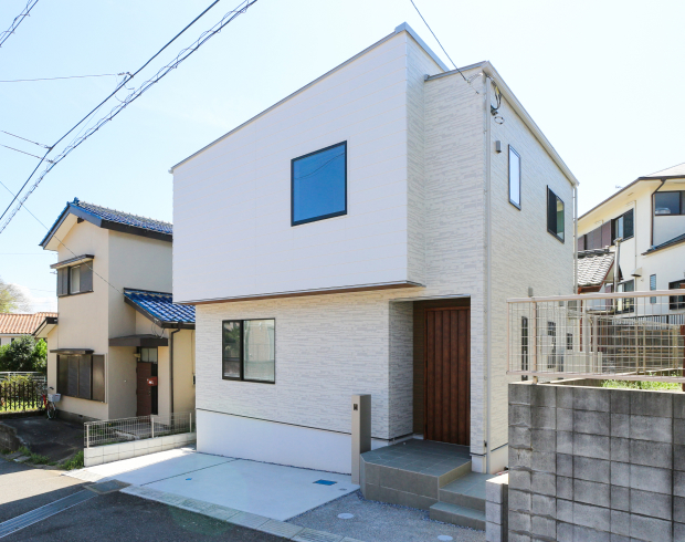 白を基調とした外観に、木の扉があたたかなアクセントを添えるモダンな佇まい。
飾りすぎない、すっきりとしたデザインが印象的です。