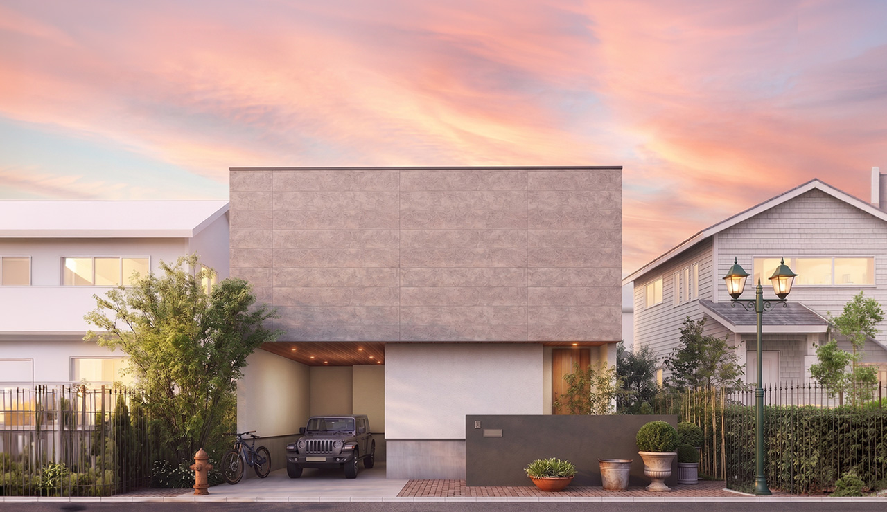 夕焼けの下に建つ、グレーと白の外壁が特徴的なガレージハウスの外観
